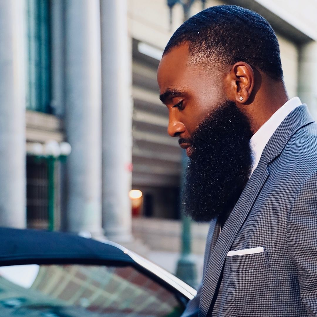 Bearded Black men in a suit with amazing beard.
